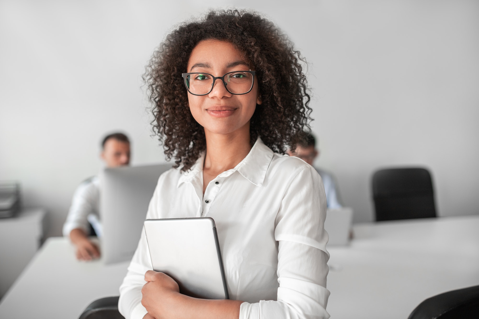 smiling-ethnic-female-recruiter-with-tablet-looking-at-camera-in-office.jpg